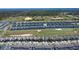 Wide aerial view of a community bordering a golf course, offering leisure and scenic views at 345 Ocean Course Ave, Davenport, FL 33896
