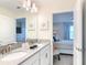 Bathroom featuring a double vanity, decorative starfish art, and a view into the bedroom at 345 Ocean Course Ave, Davenport, FL 33896
