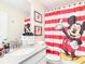Charming bathroom featuring a Mickey Mouse themed shower curtain and decor at 345 Ocean Course Ave, Davenport, FL 33896