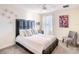 Cozy bedroom featuring a padded headboard, striped bedding, and ample natural light at 345 Ocean Course Ave, Davenport, FL 33896