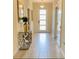Elegant entryway with tile flooring, decorative table, and mirror, offering a warm welcome at 345 Ocean Course Ave, Davenport, FL 33896