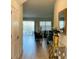 Inviting entryway flowing into a living area with comfortable seating and a view of the pool at 345 Ocean Course Ave, Davenport, FL 33896