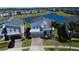 Beautiful two-story home with stone accents, a brick driveway, and a serene water view at 345 Ocean Course Ave, Davenport, FL 33896