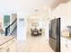 Modern kitchen with stainless steel appliances flows into a dining area near the staircase at 345 Ocean Course Ave, Davenport, FL 33896
