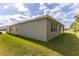 Home exterior showcasing a well-maintained backyard and multiple windows for natural light at 348 Conway Ave, St Cloud, FL 34771
