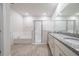 Bright bathroom with granite counters, dual sinks, large mirror and tiled floor at 348 Conway Ave, St Cloud, FL 34771