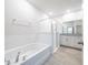 A modern bathroom featuring a tub, glass-enclosed shower, and vanity at 348 Conway Ave, St Cloud, FL 34771