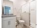 Well-lit bathroom features granite countertop, modern vanity, and glass-enclosed shower at 348 Conway Ave, St Cloud, FL 34771
