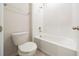 Bathroom showcasing a shower-tub combo with white tiled walls, white fixtures, and neutral colored flooring at 348 Conway Ave, St Cloud, FL 34771