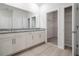 Bathroom featuring dual sink vanity, large mirror and walk-in closet at 348 Conway Ave, St Cloud, FL 34771