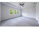 Bedroom with multiple windows, carpet flooring, and a ceiling fan at 348 Conway Ave, St Cloud, FL 34771