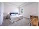 Bright bedroom with white walls, plush carpeting, and stylish blue headboard at 348 Conway Ave, St Cloud, FL 34771