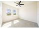Bright bedroom with plush carpeting, ample natural light, and a modern ceiling fan at 348 Conway Ave, St Cloud, FL 34771