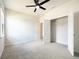 Bedroom boasting neutral walls, carpet flooring, ceiling fan, window, and a spacious closet with shelving at 348 Conway Ave, St Cloud, FL 34771
