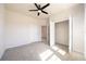 Cozy bedroom with carpet, neutral paint, closet, and a modern ceiling fan at 348 Conway Ave, St Cloud, FL 34771