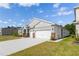 A single-Gathering home with two-car garage, set on a green lawn under a bright sky at 348 Conway Ave, St Cloud, FL 34771