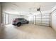 Bright garage with three garage doors and car parked inside at 348 Conway Ave, St Cloud, FL 34771