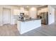 Kitchen with white cabinets, stainless steel refrigerator, and center island at 348 Conway Ave, St Cloud, FL 34771