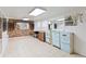 Finished basement with vintage-style cabinetry, tile flooring, and ample space for a variety of uses at 3503 S Crystal Lake Dr, Orlando, FL 32806