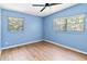 Light-filled bedroom with wood floors, neutral paint, and large windows at 3503 S Crystal Lake Dr, Orlando, FL 32806