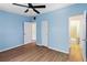 Bright blue bedroom with ceiling fan, ensuite bathroom and laminate floors at 3503 S Crystal Lake Dr, Orlando, FL 32806