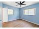 Vacant bedroom featuring a ceiling fan, two windows and laminate flooring at 3503 S Crystal Lake Dr, Orlando, FL 32806