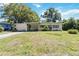 Charming single-story home with a well-manicured front yard, mature trees, and classic architectural details at 3503 S Crystal Lake Dr, Orlando, FL 32806