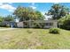 Classic one-story home featuring a well-maintained front lawn, mature trees, and charming architectural elements at 3503 S Crystal Lake Dr, Orlando, FL 32806
