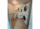 Functional laundry room with stacked washer and dryer, toilet, and sink at 3503 S Crystal Lake Dr, Orlando, FL 32806