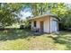 Backyard shed featuring a garage door and an additional door at 3503 S Crystal Lake Dr, Orlando, FL 32806
