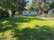 Lush backyard with mature trees and green grass at 3815 Nw Avenue R Ave, Winter Haven, FL 33881