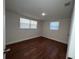 Bedroom with two windows and hardwood floors at 3815 Nw Avenue R Ave, Winter Haven, FL 33881