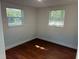 Bedroom with two windows and hardwood floors at 3815 Nw Avenue R Ave, Winter Haven, FL 33881