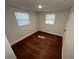 Bedroom with hardwood floors and two windows at 3815 Nw Avenue R Ave, Winter Haven, FL 33881