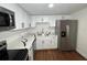 Bright kitchen featuring stainless steel appliances, quartz countertops, white cabinets, and wood-look floors at 3815 Nw Avenue R Ave, Winter Haven, FL 33881
