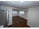 Bright living room featuring wood-look floors, neutral paint, and multiple windows for natural light at 3815 Nw Avenue R Ave, Winter Haven, FL 33881