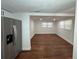 View of living room connecting to kitchen with wood-look floors, and plenty of natural light at 3815 Nw Avenue R Ave, Winter Haven, FL 33881