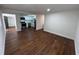 Open-concept layout connecting the living room and kitchen, featuring wood-look floors and ample natural light at 3815 Nw Avenue R Ave, Winter Haven, FL 33881