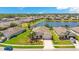 Expansive aerial view showcases a home with mature landscaping and lake views, perfect for serene living at 3894 Wind Dancer Cir, St Cloud, FL 34772