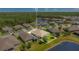Gorgeous aerial view of home showcasing its placement next to a lake and green common area at 3894 Wind Dancer Cir, St Cloud, FL 34772