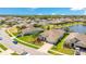 Stunning aerial view of a residential neighborhood with lush greenery and a serene lake, ideal for tranquil living at 3894 Wind Dancer Cir, St Cloud, FL 34772