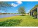 Enjoy waterfront views from this beautifully landscaped backyard overlooking the tranquil lake, perfect for nature lovers at 3894 Wind Dancer Cir, St Cloud, FL 34772