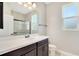 Modern bathroom with a vanity, walk-in shower, and window at 3894 Wind Dancer Cir, St Cloud, FL 34772