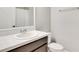 Well-lit bathroom featuring a toilet, sink, modern faucet and a large mirror at 3894 Wind Dancer Cir, St Cloud, FL 34772