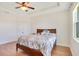 Bright bedroom features tray ceiling, hardwood floors, and natural light at 3894 Wind Dancer Cir, St Cloud, FL 34772