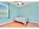 Cozy bedroom with a ceiling fan and a comfortable bed with wooden floors at 3894 Wind Dancer Cir, St Cloud, FL 34772
