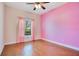 Bright bedroom with hardwood floors, a ceiling fan, and a window view to the outside at 3894 Wind Dancer Cir, St Cloud, FL 34772