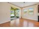 Bright dining area featuring hardwood floors, large sliding glass doors, and views of the lake at 3894 Wind Dancer Cir, St Cloud, FL 34772