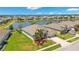 Stunning aerial view of a well-manicured property with lush landscaping and a serene lake backdrop, a true oasis at 3894 Wind Dancer Cir, St Cloud, FL 34772