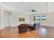 Inviting living room with hardwood floors, tray ceilings, and a large window view at 3894 Wind Dancer Cir, St Cloud, FL 34772